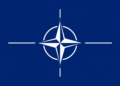 Blue flag featuring the white compass emblem of NATO, symbolizing the military alliance.