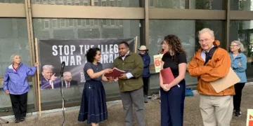 Bahar Sharafi presents the organization's letter to Senator Markey's and Warren's staff.