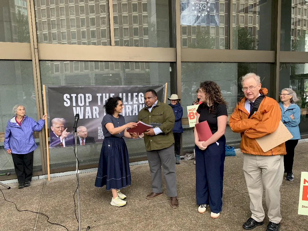 Bahar Sharafi presents the organization's letter to Senator Markey's and Warren's staff.