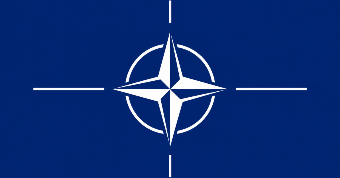 Blue flag featuring the white compass emblem of NATO, symbolizing the military alliance.