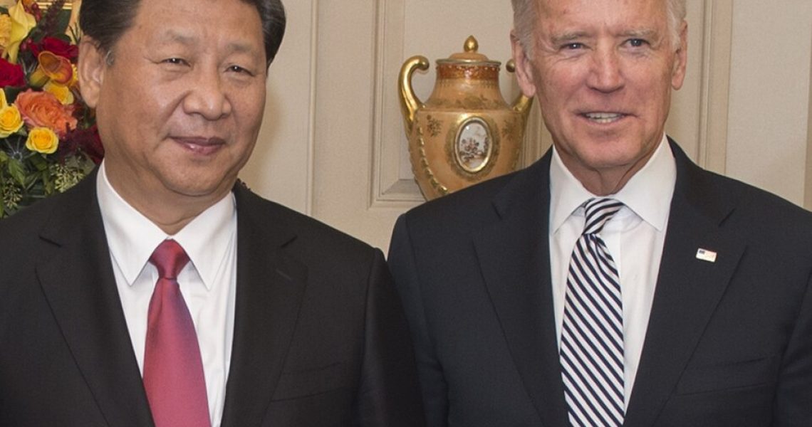 Joe Biden and Xi Jinping standing together during an official diplomatic meeting or photo opportunity.