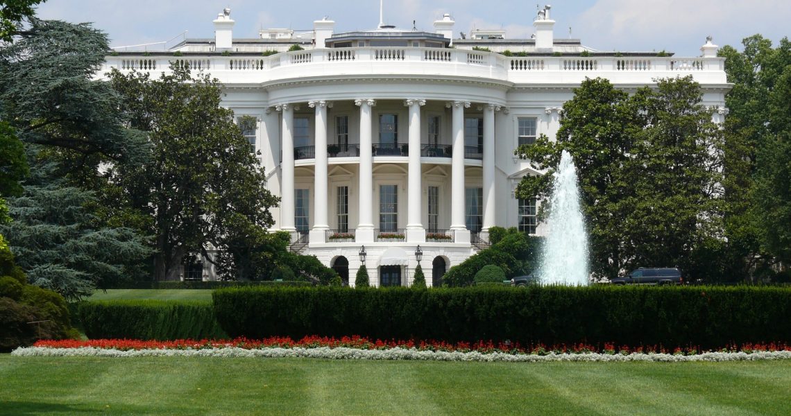 Front view of the White House in Washington, D.C., with the fountain and lawn visible in the foreground.