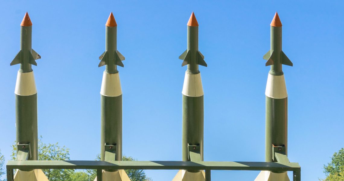 Nuclear Missiles With Warhead Aimed at Gloomy Sky. Balistic Rockets War Backgound.
