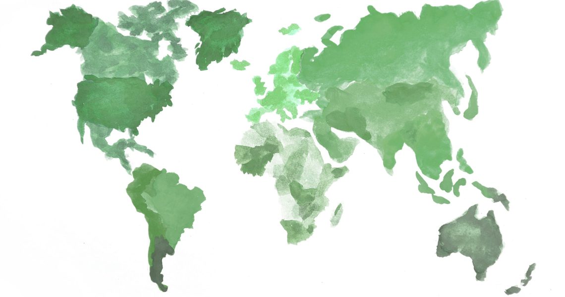 The world map is made with camouflage watercolor paints on white paper. All the world's continents are depicted in green colors