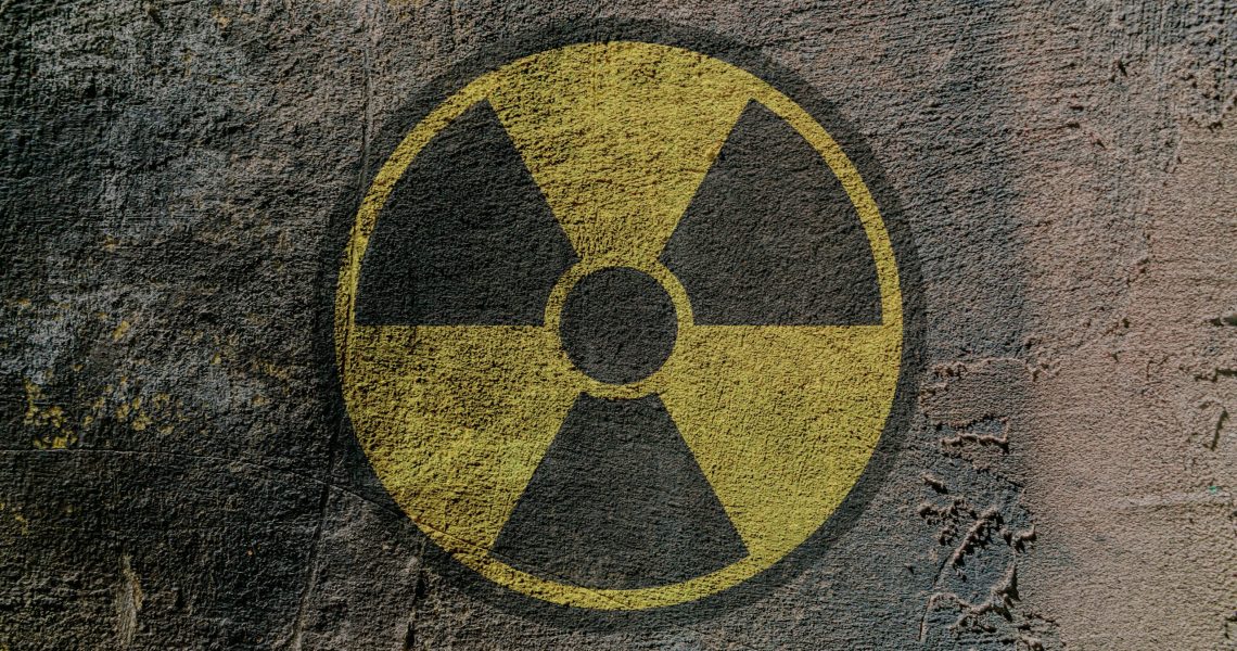 Sign of radioactive danger depicted on a concrete wall