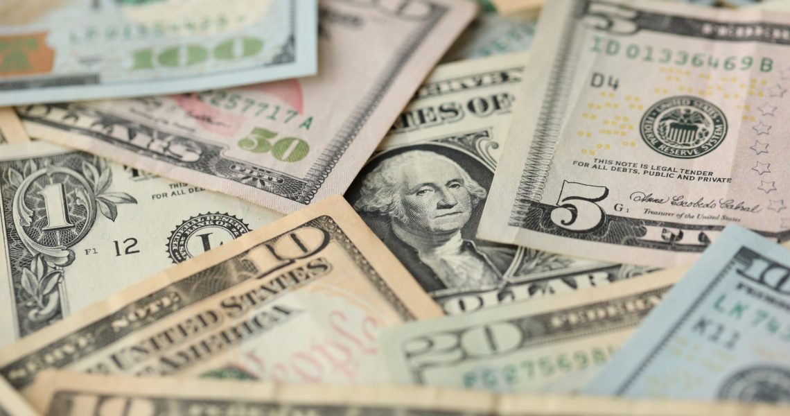 Stack of dollar bills. Hundred, fifty, twenty, ten, five dollars banknote close up view
