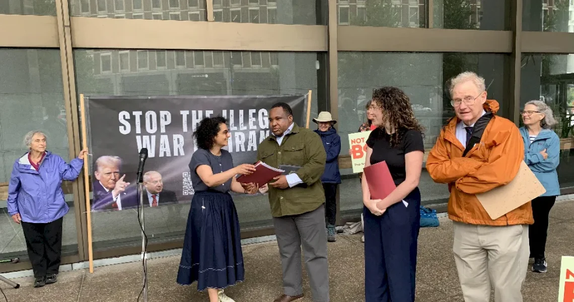 Bahar Sharafi presents the organization's letter to Senator Markey's and Warren's staff.